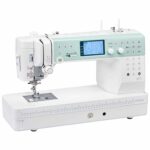 Elna Elnita EF72 computerized sewing machine with LCD screen, push button controls, and extended sewing table for quilting and garment sewing.